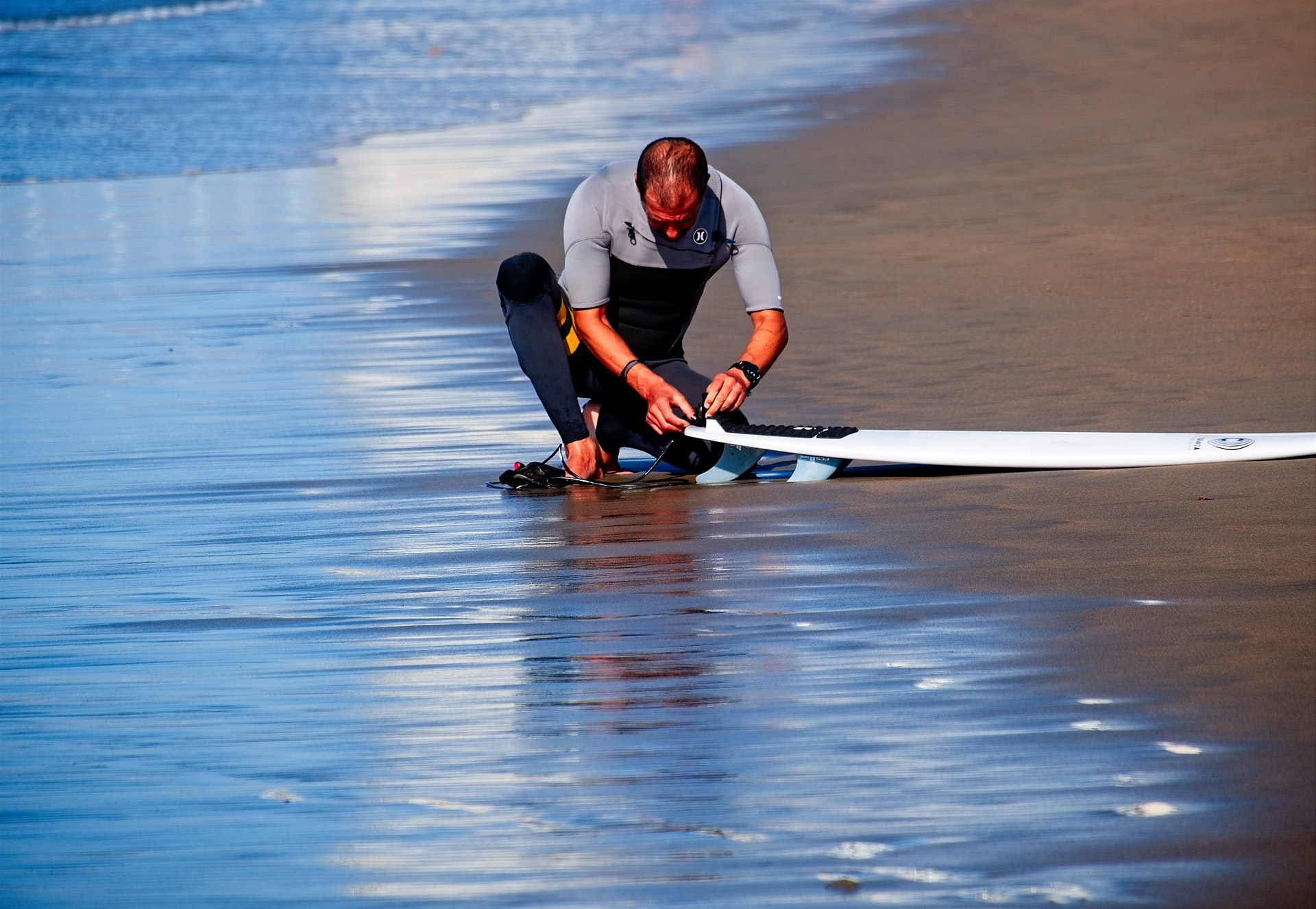 man fixing surf board